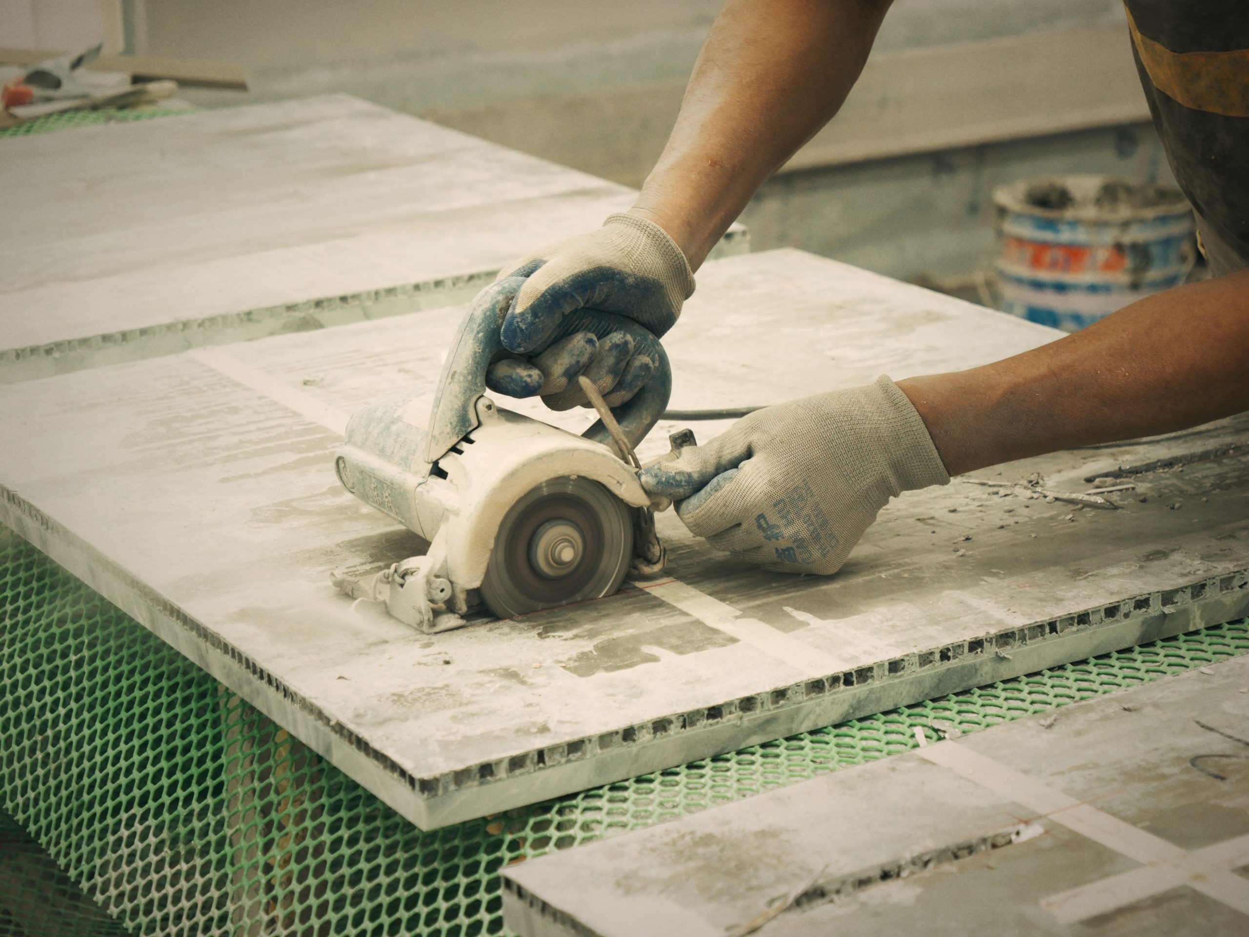 Precision bridge saw cutting natural marble slabs for custom stone fabrication at AOLEI Factory